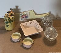 Top view of entire lot consisting of vintage ceramics, crystal apple trinket holders, porcelain pie lifter and cream lace tray.