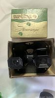Black Bakelite View-Master stereoscope inside original box with green and cream design.