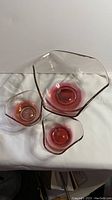 Photo of all three cranberry flash glass chip and dip bowls together showing large and two small bowls.