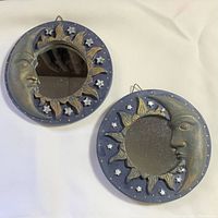 Photo showing both vintage moon and sun resin mirrors side by side on a cream background, highlighting their size and design.