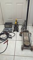 Full view of the lot showing the floor jack, two sets of jack stands, timing light, and diagnostic analyzer with cables.