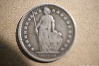 Front side of the 1907 Swiss 1/2 Franc silver coin showing the allegorical figure and stars around the edge.