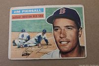 Front view of 1956 Topps Jim Piersall baseball card showing portrait and baseball action illustration plus player info and team.