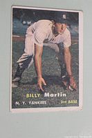 Front of 1957 Topps Billy Martin baseball card showing player in fielding pose in Yankees uniform, card number 62 visible.