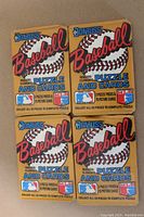 Front view of four unopened 1987 Donruss Baseball wax packs featuring puzzle and cards with Roberto Clemente on the front.