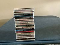 Stack of 21 Bob Dylan CDs showing album spines, arranged with titles visible to identify contents.
