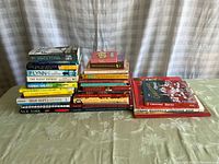 Full view of stacks of books showing a variety of titles including fiction, non-fiction, and children's Christmas story books.