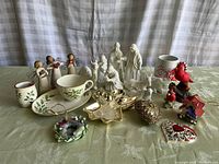 Full lot showing all items including cup and plate, angels, nativity figurines, cardinals, and ornaments