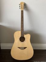 Full view of the Kanong acoustic guitar showing the natural wood finish, six steel strings, and cutaway body.