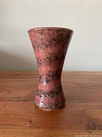 Front view of the ceramic vase showing its tapered shape and color pattern.