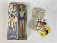 Midge doll in box with paper ephemera displayed