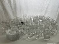 Overall view of all crystal pieces including stack of plates and assorted glasses