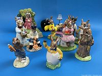 Group shot of all ten Bunnykins figurines on blue background