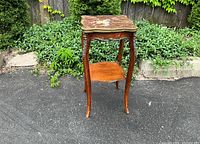 Full view of side table showing marble top, lower shelf and cabriole legs