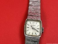 Front view of watch face showing silver-tone dial with Tudor logo and baton hour markers