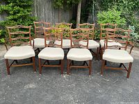 Front view of all eight chairs arranged in two rows outdoors.