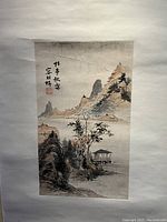Full view of unframed Chinese scroll painting mounted on white backing board