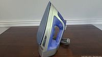 Side view of Hamilton Beach steam iron showing overall shape, handle, and power cord