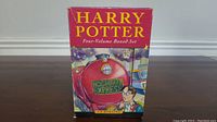 Box for Harry Potter four-volume boxed set featuring Hogwarts Express and Harry Potter illustration.