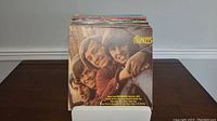 Front view of vinyl records featuring The Monkees album on top, showing album cover artwork and condition.