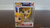 Front view of She-Ra Funko Pop #38 in original packaging showing figure and branding.