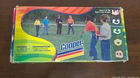 Box front showing branding and image of kids playing bocce