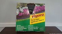 Box of Vigoro No-Dig 60ft Garden Edging showing front package with floral garden bed image and product branding and descriptions in English and French.