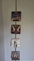 Ceiling mounted spring loaded record holder displaying all four LP records vertically