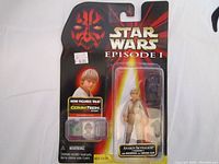 Front view of unopened Star Wars Episode I Young Anakin Skywalker action figure in original packaging, showing figure, backpack, and CommTech chip.