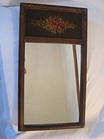 Full front view of the antique framed wall mirror showing floral painting above the mirror glass