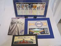 Overview showing framed memorabilia including team ticket, Opening Day card, and Rockies themed backing.