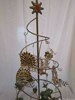 Full view of the metal spiral tree with multiple cloisonné ornaments hanging