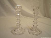 Front view of the two clear Mikasa crystal candle holders showing hexagonal bases and faceted stems from a slight angle