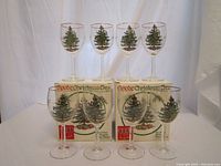 Full set of 8 Spode Christmas Tree pattern wine glasses with original boxes behind.