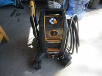 Front view of the Spyder PowerPlay pressure washer showing main unit, dial, and hose on the side.