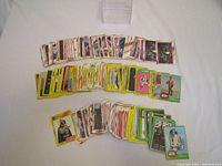 Three stacks of Star Wars collector cards arranged face-up, showing characters and scenes, various border colors including yellow and white.