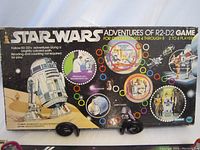 Box featuring Star Wars branding and image of R2D2 with a colorful path and character images on the front.