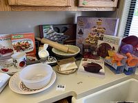 Overview of baking items on kitchen counter including bakeware, utensils, and cookbooks.