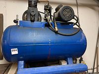 Front view of blue compressor tank with pump and motor