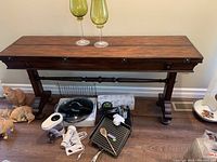 Front view of table with leaves folded down showing overall shape and finish