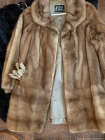 Mitchel Furs light brown mink fur coat with gloves on wooden floor