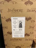 Box label showing item number 4022919 and title 'Spreading Joy' Classic Santa Holding Snowman/Toys Figurine