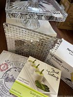Overview of crystal platter atop decorative tray with cookbook and original boxes.