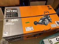 Front of original cardboard box showing WORX Nitro branding and mower graphic