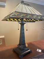 Full view of the Tiffany-style table lamp showing base and shade with stained glass panels.