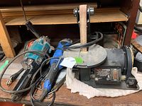 Photo showing Craftsman belt/disc sander, Makita sander and polisher together on a wooden surface.