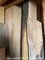 Close up of various wood slabs with natural grain and live edge showing bark and rough edges