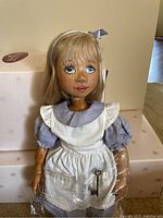 Front view of Alice in Wonderland wooden doll in original packaging with box