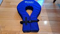 Full view of Kiefer Aquatics blue foam swim collar with black adjustable strap and buckle.