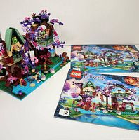 Overall view of the assembled LEGO Elves Treetop Hideaway set with instruction books beside it